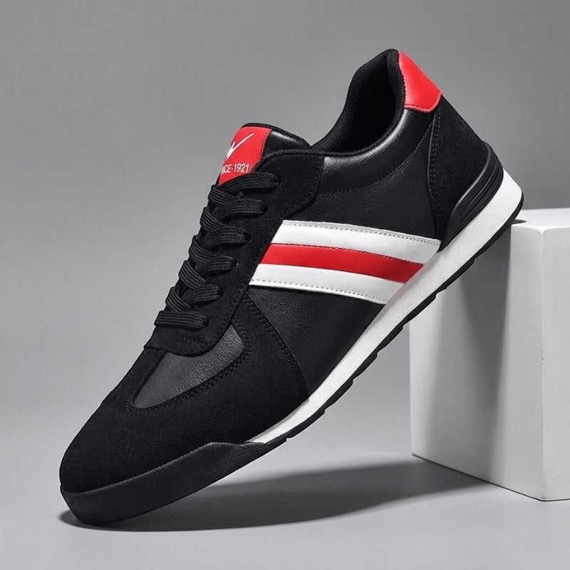 Zapatillas deportivas negras de piel auténtica Alma Cruz con rayas rojas y blancas, suela acolchada y diseño retro.