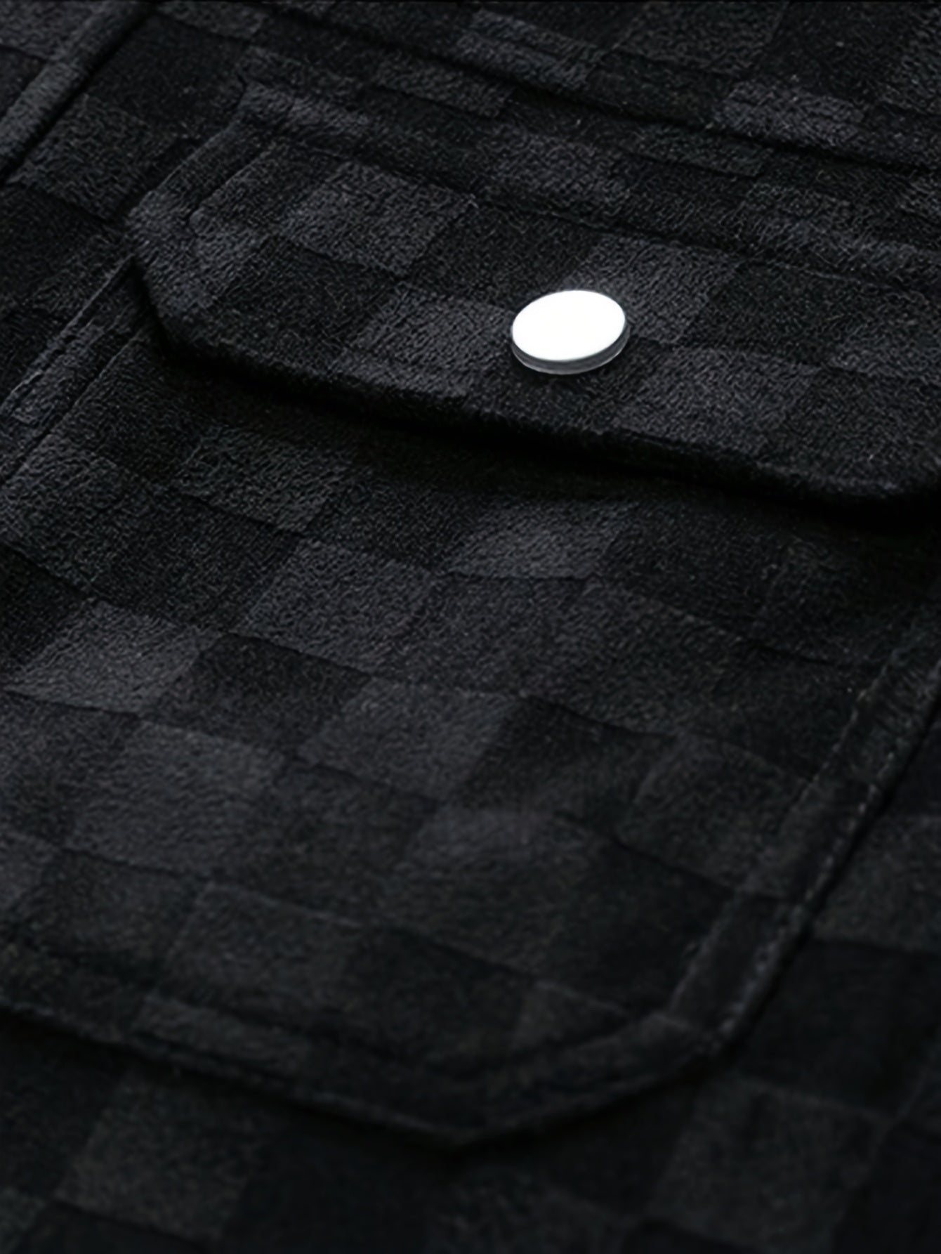 Chaqueta negra de ante de terciopelo con textura de cuadros, bolsillos con solapa y broches. Marca Alma Cruz.