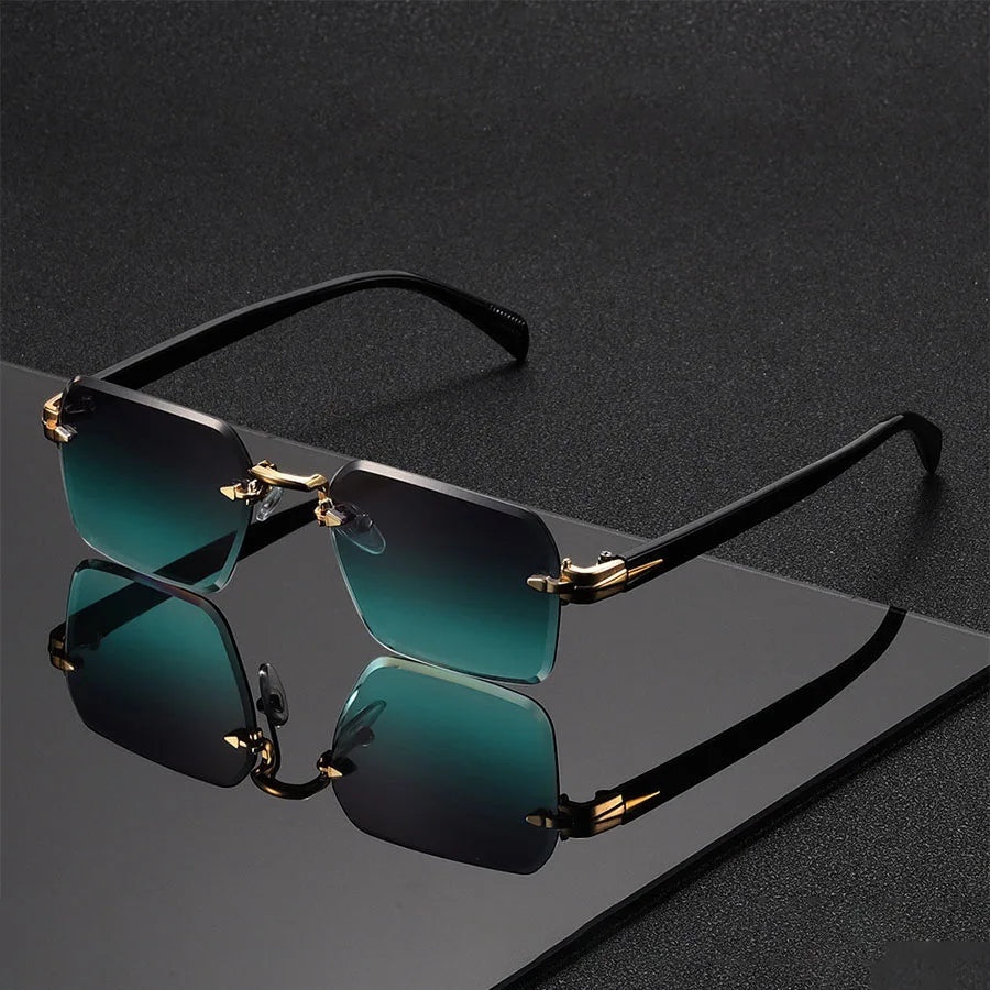 Alma Cruz Gafas de sol Fausto sin montura con lentes degradado verde y detalles dorados. Patillas negras finas.