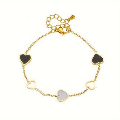 Brazalete Alma Cruz de acero inoxidable bañado en oro con corazones de esmalte negro, blanco y dorado. Ajustable.